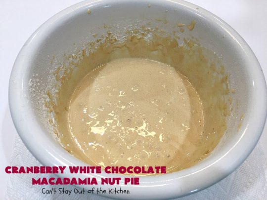 Cranberry White Chocolate Macadamia Nut Pie | Can't Stay Out of the Kitchen | this irresistible #pie is made with dried #cranberries, #MacadamiaNuts & #WhiteChocolateChips. It's so rich & decadent you'll be hooked from your first bite. Wonderful for #holiday parties and #Christmas dinner menus. #chocolate #dessert #Craisins #HolidayDessert #ChocolateDessert #CranberryDessert #CranberryWhiteChocolateMacadamiaNutPie
