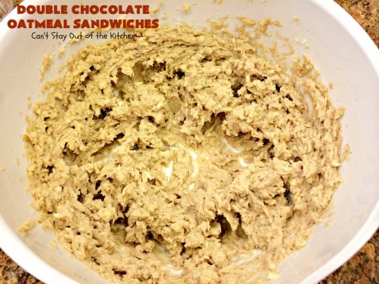 Double Chocolate Oatmeal Cookies | Can't Stay Out of the Kitchen | these spectacular #OatmealCookies feature #ChocolateChips in the #cookies and a #chocolate #fudge frosting sandwiched between to die for! Amazing #dessert for #holiday #ChristmasCookie baking. #ChristmasCookieExchange #FallBaking #DoubleChocolateOatmealSandwiches #ChocolateFudgeFrosting #HolidayDessert
