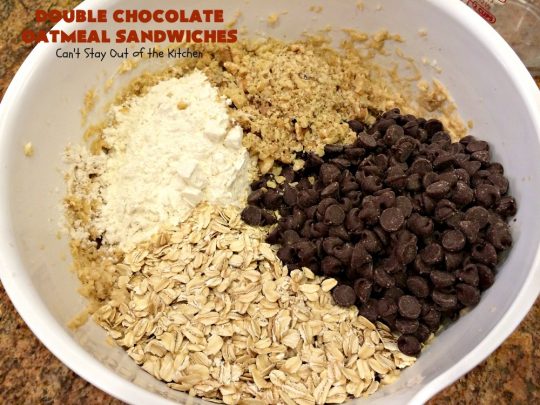 Double Chocolate Oatmeal Cookies | Can't Stay Out of the Kitchen | these spectacular #OatmealCookies feature #ChocolateChips in the #cookies and a #chocolate #fudge frosting sandwiched between to die for! Amazing #dessert for #holiday #ChristmasCookie baking. #ChristmasCookieExchange #FallBaking #DoubleChocolateOatmealSandwiches #ChocolateFudgeFrosting #HolidayDessert