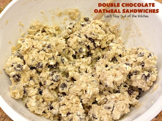 Double Chocolate Oatmeal Cookies | Can't Stay Out of the Kitchen | these spectacular #OatmealCookies feature #ChocolateChips in the #cookies and a #chocolate #fudge frosting sandwiched between to die for! Amazing #dessert for #holiday #ChristmasCookie baking. #ChristmasCookieExchange #FallBaking #DoubleChocolateOatmealSandwiches #ChocolateFudgeFrosting #HolidayDessert