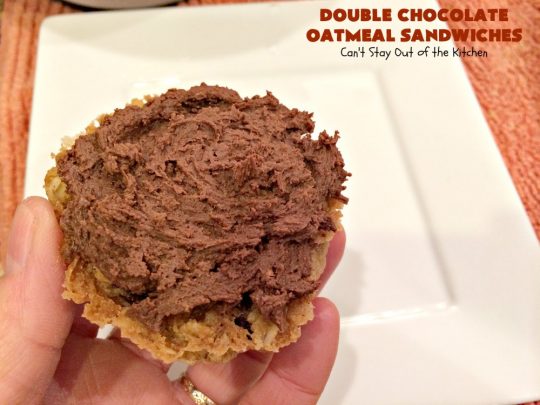 Double Chocolate Oatmeal Cookies | Can't Stay Out of the Kitchen | these spectacular #OatmealCookies feature #ChocolateChips in the #cookies and a #chocolate #fudge frosting sandwiched between to die for! Amazing #dessert for #holiday #ChristmasCookie baking. #ChristmasCookieExchange #FallBaking #DoubleChocolateOatmealSandwiches #ChocolateFudgeFrosting #HolidayDessert