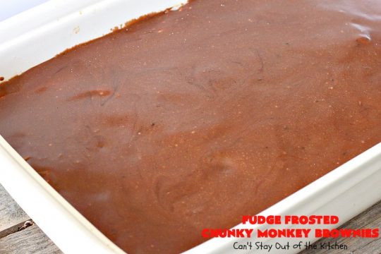 Fudge Frosted Chunky Monkey Brownies | Can't Stay Out of the Kitchen | These heavenly #brownies have #chocolate chunks in the batter & #fudge frosting on top. This addictive #dessert has triple the chocolate threat when you add ice cream & #Ghirardelli chocolate sauce on top!