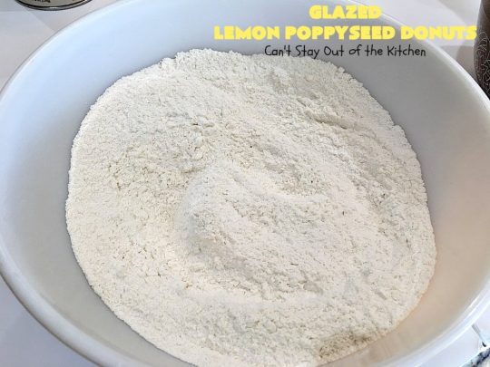 Glazed Lemon Poppyseed Donuts | Can't Stay Out of the Kitchen | these #donuts are awesome! They have #lemon juice & lemon zest in both the donut and icing. Terrific for a weekend or #holiday #breakfast. #poppyseeds #HolidayBreakfast #LemonPoppyseedDonuts #HomemadeDonuts