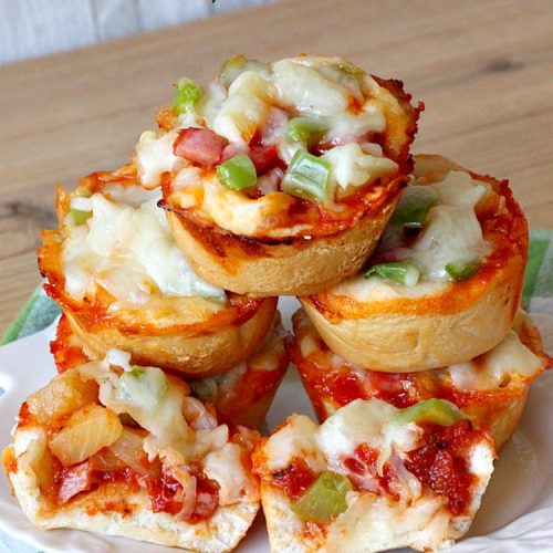 Hawaiian Pizza Cups | Can't Stay Out of the Kitchen | these fantastic miniature #pizzas are the best #appetizer of choice for #tailgating parties or the #SuperBowl! They're filled with spaghetti sauce, #ham, #pineapple & green bell pepper. Every bite is so mouthwatering, you'll be fighting others for the last one! #MozzarellaCheese #PillsburyRefrigeratedBiscuits #MiniaturePizzas #HawaiianPizzaCups