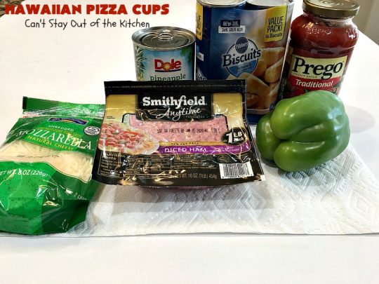 Hawaiian Pizza Cups | Can't Stay Out of the Kitchen | these fantastic miniature #pizzas are the best #appetizer of choice for #tailgating parties or the #SuperBowl! They're filled with spaghetti sauce, #ham, #pineapple & green bell pepper. Every bite is so mouthwatering, you'll be fighting others for the last one! #MozzarellaCheese #PillsburyRefrigeratedBiscuits #MiniaturePizzas #HawaiianPizzaCups
