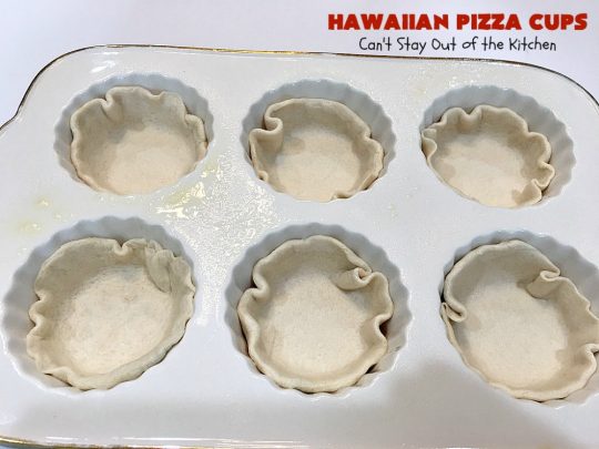 Hawaiian Pizza Cups | Can't Stay Out of the Kitchen | these fantastic miniature #pizzas are the best #appetizer of choice for #tailgating parties or the #SuperBowl! They're filled with spaghetti sauce, #ham, #pineapple & green bell pepper. Every bite is so mouthwatering, you'll be fighting others for the last one! #MozzarellaCheese #PillsburyRefrigeratedBiscuits #MiniaturePizzas #HawaiianPizzaCups
