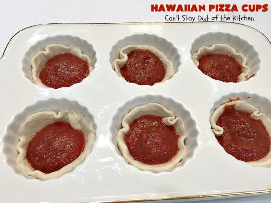 Hawaiian Pizza Cups | Can't Stay Out of the Kitchen | these fantastic miniature #pizzas are the best #appetizer of choice for #tailgating parties or the #SuperBowl! They're filled with spaghetti sauce, #ham, #pineapple & green bell pepper. Every bite is so mouthwatering, you'll be fighting others for the last one! #MozzarellaCheese #PillsburyRefrigeratedBiscuits #MiniaturePizzas #HawaiianPizzaCups