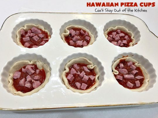 Hawaiian Pizza Cups | Can't Stay Out of the Kitchen | these fantastic miniature #pizzas are the best #appetizer of choice for #tailgating parties or the #SuperBowl! They're filled with spaghetti sauce, #ham, #pineapple & green bell pepper. Every bite is so mouthwatering, you'll be fighting others for the last one! #MozzarellaCheese #PillsburyRefrigeratedBiscuits #MiniaturePizzas #HawaiianPizzaCups