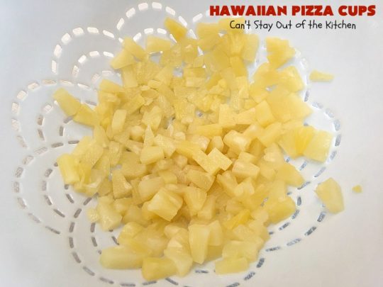 Hawaiian Pizza Cups | Can't Stay Out of the Kitchen | these fantastic miniature #pizzas are the best #appetizer of choice for #tailgating parties or the #SuperBowl! They're filled with spaghetti sauce, #ham, #pineapple & green bell pepper. Every bite is so mouthwatering, you'll be fighting others for the last one! #MozzarellaCheese #PillsburyRefrigeratedBiscuits #MiniaturePizzas #HawaiianPizzaCups