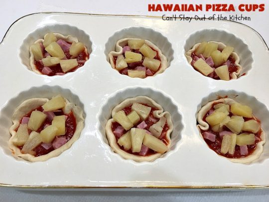 Hawaiian Pizza Cups | Can't Stay Out of the Kitchen | these fantastic miniature #pizzas are the best #appetizer of choice for #tailgating parties or the #SuperBowl! They're filled with spaghetti sauce, #ham, #pineapple & green bell pepper. Every bite is so mouthwatering, you'll be fighting others for the last one! #MozzarellaCheese #PillsburyRefrigeratedBiscuits #MiniaturePizzas #HawaiianPizzaCups