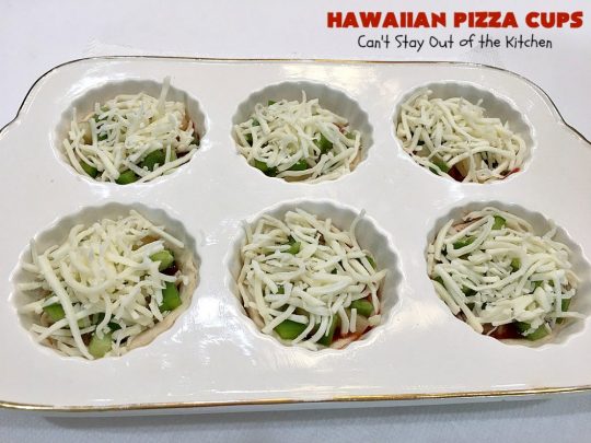 Hawaiian Pizza Cups | Can't Stay Out of the Kitchen | these fantastic miniature #pizzas are the best #appetizer of choice for #tailgating parties or the #SuperBowl! They're filled with spaghetti sauce, #ham, #pineapple & green bell pepper. Every bite is so mouthwatering, you'll be fighting others for the last one! #MozzarellaCheese #PillsburyRefrigeratedBiscuits #MiniaturePizzas #HawaiianPizzaCups