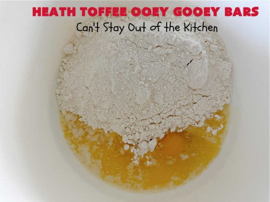 Heath Toffee Ooey Gooey Bars | Can't Stay Out of the Kitchen | These #OoeyGooeyBars are outrageously good! If you want an earth-shattering experience, bake up a batch of these lovely #brownies for your next #tailgating party, potluck or backyard BBQ. This easy #recipe uses only 6 ingredients! #cookies #dessert #HeathEnglishToffeeBits #HeathToffee #HeathToffeeOoeyGooeyBars