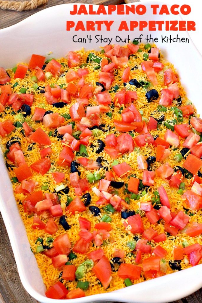 Jalapeno Taco Party Appetizer | Can't Stay Out of the Kitchen | the best #TexMex layered dip ever! This one uses refried beans with jalapenos, #avocados, a sour cream & #taco seasoning layer. Then it's topped with olives, #cheese, green onions and tomatoes. Perfect for #tailgating or #SuperBowl parties. #appetizer
