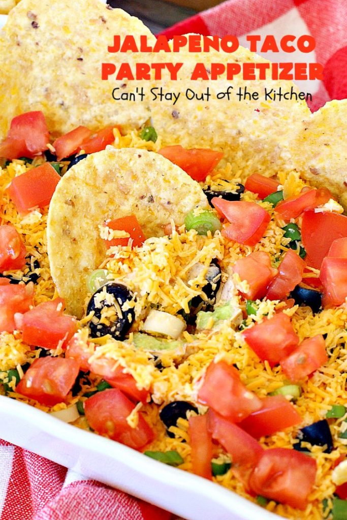 Jalapeno Taco Party Appetizer | Can't Stay Out of the Kitchen | the best #TexMex layered dip ever! This one uses refried beans with jalapenos, #avocados, a sour cream & #taco seasoning layer. Then it's topped with olives, #cheese, green onions and tomatoes. Perfect for #tailgating or #SuperBowl parties. #appetizer