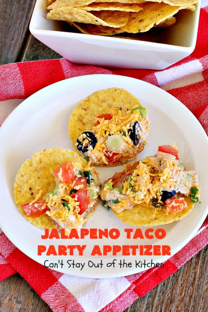 Jalapeno Taco Party Appetizer | Can't Stay Out of the Kitchen | the best #TexMex layered dip ever! This one uses refried beans with jalapenos, #avocados, a sour cream & #taco seasoning layer. Then it's topped with olives, #cheese, green onions and tomatoes. Perfect for #tailgating or #SuperBowl parties. #appetizer