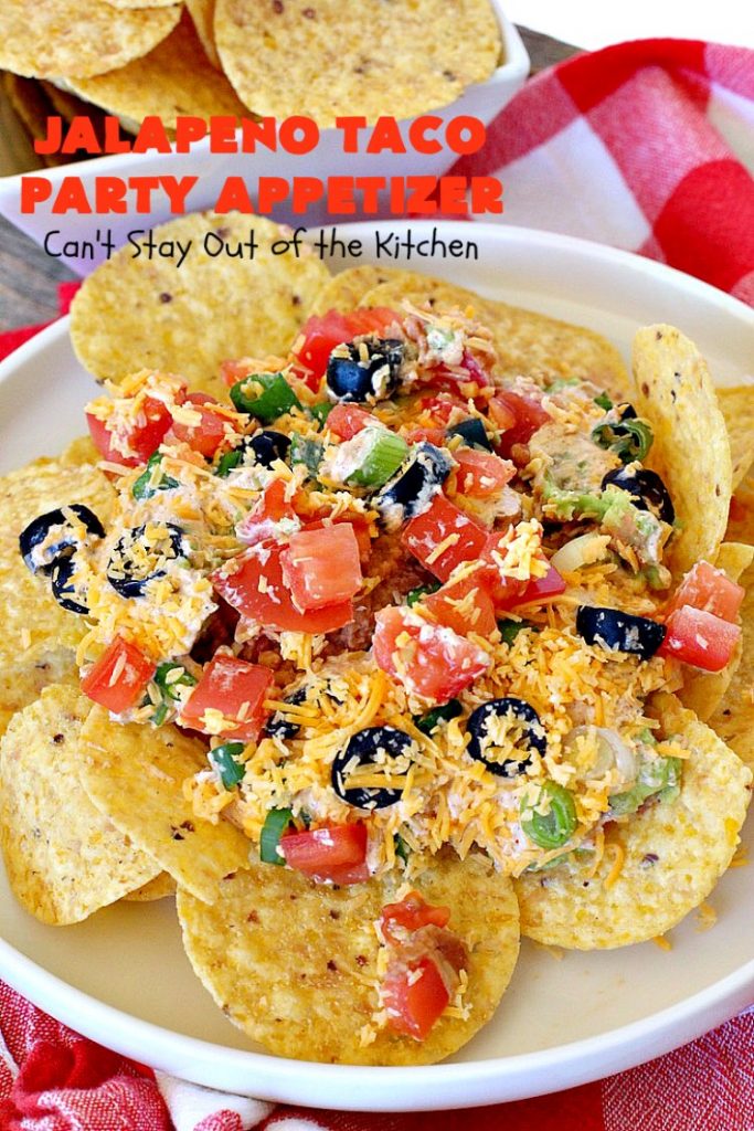 Jalapeno Taco Party Appetizer | Can't Stay Out of the Kitchen | the best #TexMex layered dip ever! This one uses refried beans with jalapenos, #avocados, a sour cream & #taco seasoning layer. Then it's topped with olives, #cheese, green onions and tomatoes. Perfect for #tailgating or #SuperBowl parties. #appetizer