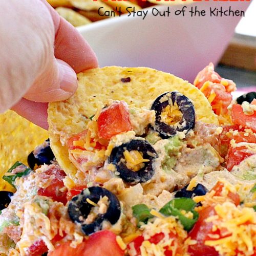 Jalapeno Taco Party Appetizer | Can't Stay Out of the Kitchen | the best #TexMex layered dip ever! This one uses refried beans with jalapenos, #avocados, a sour cream & #taco seasoning layer. Then it's topped with olives, #cheese, green onions and tomatoes. Perfect for #tailgating or #SuperBowl parties. #appetizer