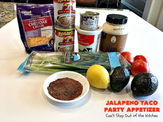 Jalapeno Taco Party Appetizer | Can't Stay Out of the Kitchen | the best #TexMex layered dip ever! This one uses refried beans with jalapenos, #avocados, a sour cream & #taco seasoning layer. Then it's topped with olives, #cheese, green onions and tomatoes. Perfect for #tailgating or #SuperBowl parties. #appetizer
