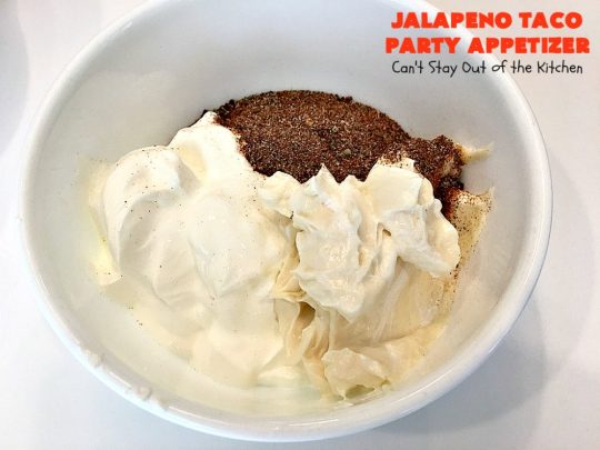 Jalapeno Taco Party Appetizer | Can't Stay Out of the Kitchen | the best #TexMex layered dip ever! This one uses refried beans with jalapenos, #avocados, a sour cream & #taco seasoning layer. Then it's topped with olives, #cheese, green onions and tomatoes. Perfect for #tailgating or #SuperBowl parties. #appetizer