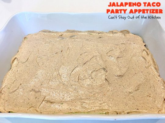 Jalapeno Taco Party Appetizer | Can't Stay Out of the Kitchen | the best #TexMex layered dip ever! This one uses refried beans with jalapenos, #avocados, a sour cream & #taco seasoning layer. Then it's topped with olives, #cheese, green onions and tomatoes. Perfect for #tailgating or #SuperBowl parties. #appetizer