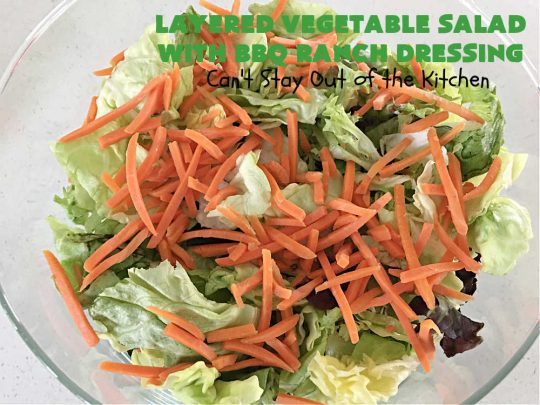 Layered Vegetable Salad with BBQ Ranch Dressing is spectacular! This amazing #salad uses all kinds of fresh #veggies, plus #bacon & two kinds of #cheese: #Cheddar & #MontereyJack. The #BBQRanchDressing is what gives the #recipe such amazing flavor. This #LayeredSalad is terrific for company or #holiday dinners & is #GlutenFree. #eggs #LayeredVegetableSaladWith BBQRanchDressing