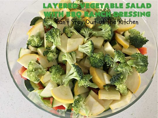 Layered Vegetable Salad with BBQ Ranch Dressing is spectacular! This amazing #salad uses all kinds of fresh #veggies, plus #bacon & two kinds of #cheese: #Cheddar & #MontereyJack. The #BBQRanchDressing is what gives the #recipe such amazing flavor. This #LayeredSalad is terrific for company or #holiday dinners & is #GlutenFree. #eggs #LayeredVegetableSaladWith BBQRanchDressing