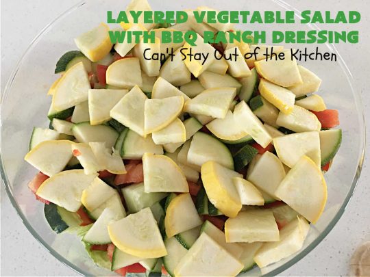 Layered Vegetable Salad with BBQ Ranch Dressing is spectacular! This amazing #salad uses all kinds of fresh #veggies, plus #bacon & two kinds of #cheese: #Cheddar & #MontereyJack. The #BBQRanchDressing is what gives the #recipe such amazing flavor. This #LayeredSalad is terrific for company or #holiday dinners & is #GlutenFree. #eggs #LayeredVegetableSaladWith BBQRanchDressing