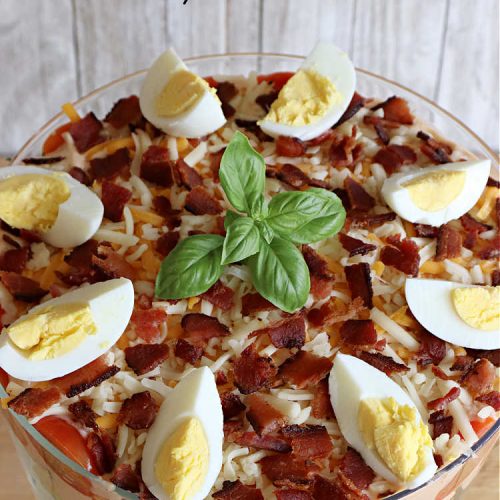 Layered Vegetable Salad with BBQ Ranch Dressing is spectacular! This amazing #salad uses all kinds of fresh #veggies, plus #bacon & two kinds of #cheese: #Cheddar & #MontereyJack. The #BBQRanchDressing is what gives the #recipe such amazing flavor. This #LayeredSalad is terrific for company or #holiday dinners & is #GlutenFree. #eggs #LayeredVegetableSaladWith BBQRanchDressing