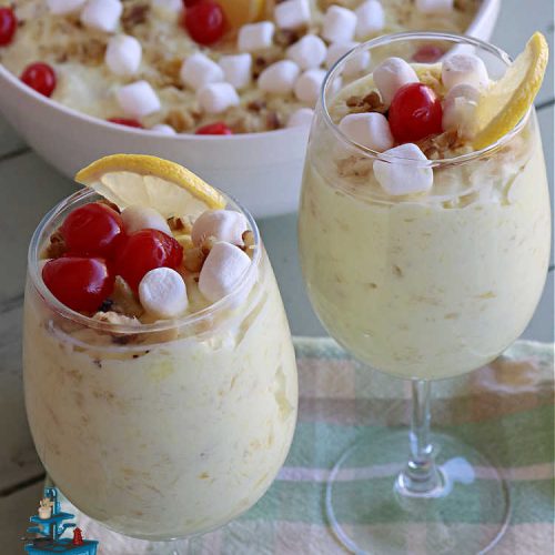 Lemon Cheesecake Fluff | Can't Stay Out of the Kitchen | this spectacular "fluff"-type #FruitSalad is terrific for company or #holiday dinners. It includes #CreamCheese, #CheesecakePuddingMix, #Lemon #JellO, miniature #marshmallows, #CoolWhip & #walnuts.Serve it in a trifle dish, glass bowl or parfait glasses for special occasions. #LemonCheesecakeFluff #salad