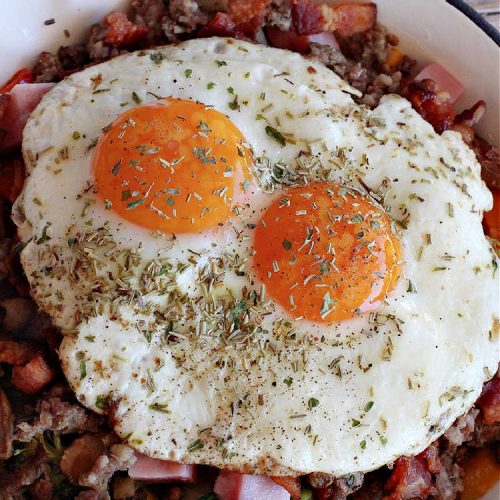 Loaded Porky Pig Breakfast Skillet | Can't Stay Out of the Kitchen | this fantastic #BreakfastSkillet includes #ham, #sausage & #bacon along with lots of fresh veggies, two kinds of #cheese, #HashBrowns & #eggs. It's irresistible & mouthwatering along with being a very filling and satisfying #breakfast entree for weekends or #holidays. If you enjoy big breakfasts, this one can't be beat! #LoadedPorkyPigBreakfastSkillet #pork #SkilletBreakfast #MontereyJackCheese #CheddarCheese