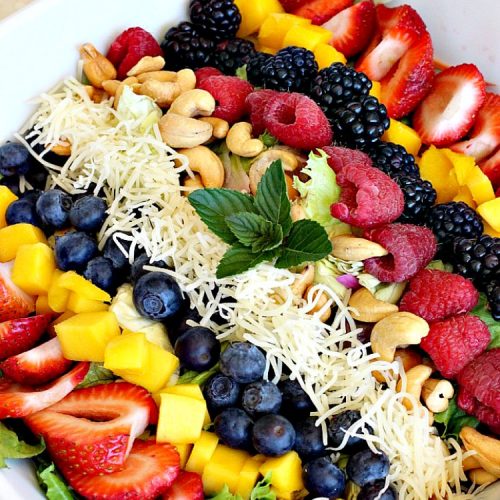 Mango Berry Salad with Mango Poppyseed Dressing | Can't Stay Out of the Kitchen | this amazing #salad has double the #mango flavor. Filled with #strawberries #raspberries #blueberries #blackberries & #swisscheese. We love this #salad. #glutenfree #cleaneating