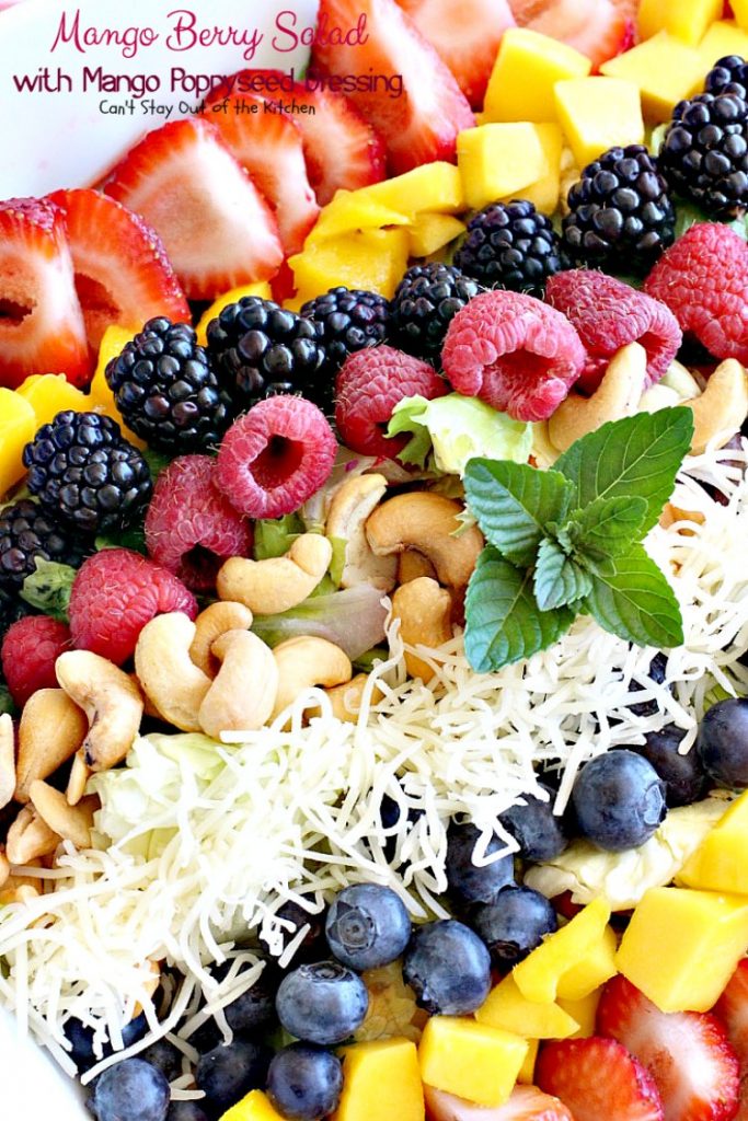 Mango Berry Salad with Mango Poppyseed Dressing | Can't Stay Out of the Kitchen | this amazing #salad has double the #mango flavor. Filled with #strawberries #raspberries #blueberries #blackberries & #swisscheese. We love this #salad. #glutenfree #cleaneating