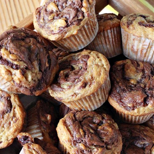 Nutella Swirl Banana Muffins | Can't Stay Out of the Kitchen | these outrageous #muffins are filled with #almonds & #bananas and swirled with #Nutella! These are so heavenly you won't be able to stay out of them. #breakfast #holiday #HolidayBreakfast #NutellaMuffins #NutellaSwirlBananaMuffins
