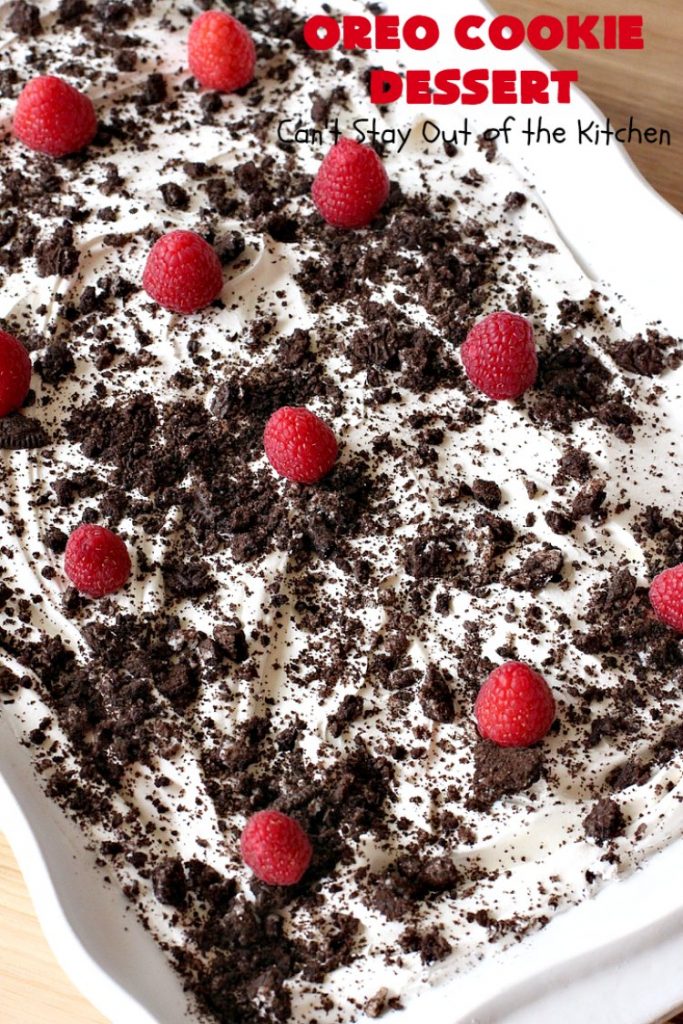 Oreo Cookie Dessert | Can't Stay Out of the Kitchen | This spectacular #dessert is rich, decadent & so addictive! No one will want only one piece! The bottom layer is crushed #Oreos. Layered with #BlueBell vanilla ice cream, then it has a homemade #fudge & walnut sauce. It's topped with #CoolWhip & more #Oreos. #OreoDessert #ChocolateDessert #IceCreamDessert #FudgeDessert #ValentinesDayDessert #HolidayDessert