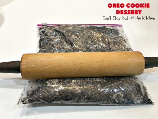 Oreo Cookie Dessert | Can't Stay Out of the Kitchen | This spectacular #dessert is rich, decadent & so addictive! No one will want only one piece! The bottom layer is crushed #Oreos. Layered with #BlueBell vanilla ice cream, then it has a homemade #fudge & walnut sauce. It's topped with #CoolWhip & more #Oreos. #OreoDessert #ChocolateDessert #IceCreamDessert #FudgeDessert #ValentinesDayDessert #HolidayDessert