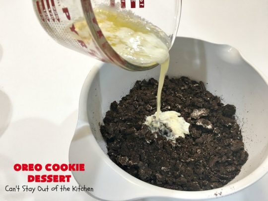 Oreo Cookie Dessert | Can't Stay Out of the Kitchen | This spectacular #dessert is rich, decadent & so addictive! No one will want only one piece! The bottom layer is crushed #Oreos. Layered with #BlueBell vanilla ice cream, then it has a homemade #fudge & walnut sauce. It's topped with #CoolWhip & more #Oreos. #OreoDessert #ChocolateDessert #IceCreamDessert #FudgeDessert #ValentinesDayDessert #HolidayDessert