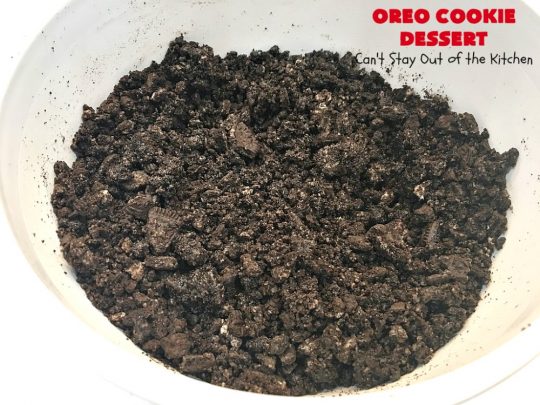 Oreo Cookie Dessert | Can't Stay Out of the Kitchen | This spectacular #dessert is rich, decadent & so addictive! No one will want only one piece! The bottom layer is crushed #Oreos. Layered with #BlueBell vanilla ice cream, then it has a homemade #fudge & walnut sauce. It's topped with #CoolWhip & more #Oreos. #OreoDessert #ChocolateDessert #IceCreamDessert #FudgeDessert #ValentinesDayDessert #HolidayDessert
