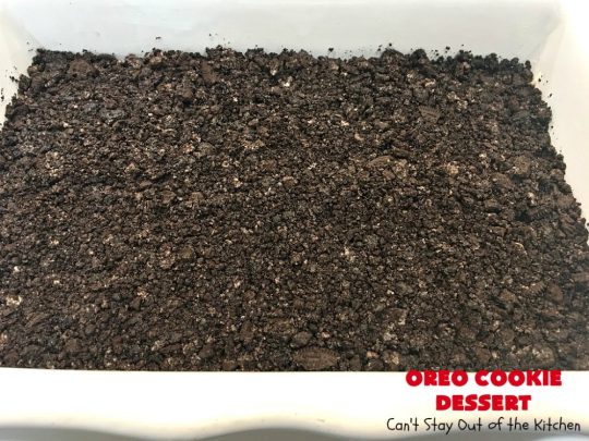 Oreo Cookie Dessert | Can't Stay Out of the Kitchen | This spectacular #dessert is rich, decadent & so addictive! No one will want only one piece! The bottom layer is crushed #Oreos. Layered with #BlueBell vanilla ice cream, then it has a homemade #fudge & walnut sauce. It's topped with #CoolWhip & more #Oreos. #OreoDessert #ChocolateDessert #IceCreamDessert #FudgeDessert #ValentinesDayDessert #HolidayDessert