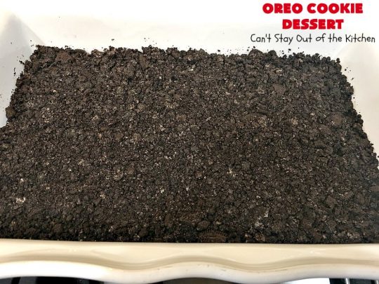Oreo Cookie Dessert | Can't Stay Out of the Kitchen | This spectacular #dessert is rich, decadent & so addictive! No one will want only one piece! The bottom layer is crushed #Oreos. Layered with #BlueBell vanilla ice cream, then it has a homemade #fudge & walnut sauce. It's topped with #CoolWhip & more #Oreos. #OreoDessert #ChocolateDessert #IceCreamDessert #FudgeDessert #ValentinesDayDessert #HolidayDessert