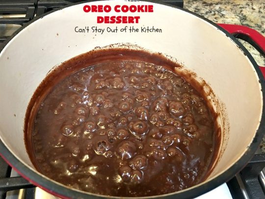 Oreo Cookie Dessert | Can't Stay Out of the Kitchen | This spectacular #dessert is rich, decadent & so addictive! No one will want only one piece! The bottom layer is crushed #Oreos. Layered with #BlueBell vanilla ice cream, then it has a homemade #fudge & walnut sauce. It's topped with #CoolWhip & more #Oreos. #OreoDessert #ChocolateDessert #IceCreamDessert #FudgeDessert #ValentinesDayDessert #HolidayDessert