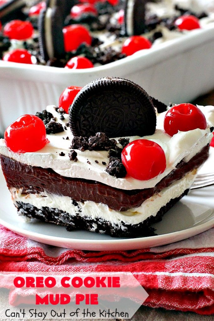 Oreo Cookie Mud Pie | Can't Stay Out of the Kitchen | this spectacular layered #dessert has an #Oreo crust, a #cheesecake layer, a #chocolate #pudding layer, and a #CoolWhip layer with #maraschinocherries. This amazing dessert is always raved over whenever I make it! #chocolatedessert #OreoDessert