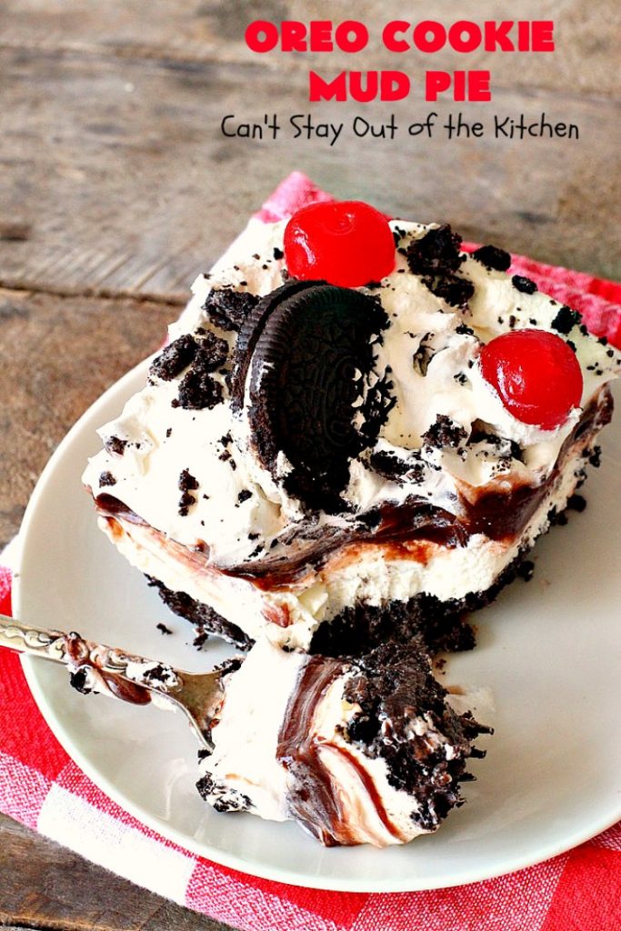 Oreo Cookie Mud Pie | Can't Stay Out of the Kitchen | this spectacular layered #dessert has an #Oreo crust, a #cheesecake layer, a #chocolate #pudding layer, and a #CoolWhip layer with #maraschinocherries. This amazing dessert is always raved over whenever I make it! #chocolatedessert #OreoDessert