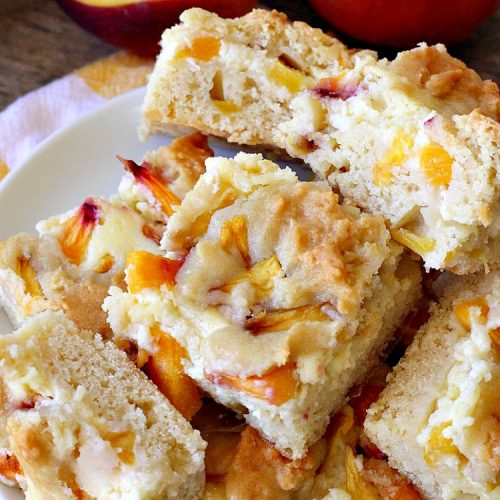 Peach Cobbler Cheesecake Brownies | Can't Stay Out of the Kitchen | these spectacular #brownies start with a #peachcobbler #cookie dough. They have a luscious #cheesecake filling in the middle, topped with fresh #peaches. Then more cookie dough is crumbled over top. These were a huge hit at my husband's office. #dessert #peachdessert #CANbassador #WashingtonStateFruitCommission #WashingtonStatestoneFruitGrowers