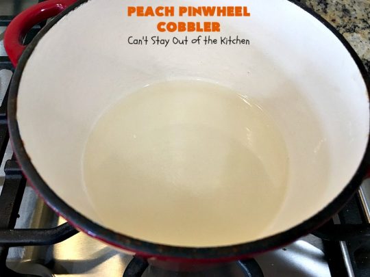 Peach Pinwheel Cobbler | Can't Stay Out of the Kitchen | this is one fantastic #PeachCobbler! #Peaches are wrapped up in dough pinwheel fashion. Syrup is poured over top before baking. The pinwheels absorb the syrup & puff up really large. This is absolutely heavenly. Wonderful #summer #dessert. #PeachDessert #cobbler #PeachPinwheelCobbler #Canbassador #WashingtonStateFruitCommission #WashingtonStoneFruitGrowers #WashingtonStateStoneFruitGrowers