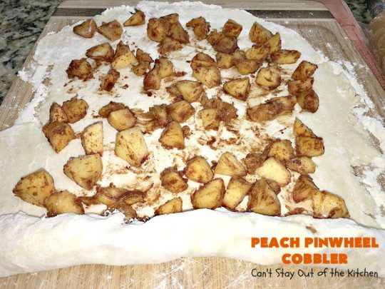 Peach Pinwheel Cobbler | Can't Stay Out of the Kitchen | this is one fantastic #PeachCobbler! #Peaches are wrapped up in dough pinwheel fashion. Syrup is poured over top before baking. The pinwheels absorb the syrup & puff up really large. This is absolutely heavenly. Wonderful #summer #dessert. #PeachDessert #cobbler #PeachPinwheelCobbler #Canbassador #WashingtonStateFruitCommission #WashingtonStoneFruitGrowers #WashingtonStateStoneFruitGrowers