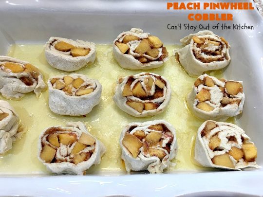 Peach Pinwheel Cobbler | Can't Stay Out of the Kitchen | this is one fantastic #PeachCobbler! #Peaches are wrapped up in dough pinwheel fashion. Syrup is poured over top before baking. The pinwheels absorb the syrup & puff up really large. This is absolutely heavenly. Wonderful #summer #dessert. #PeachDessert #cobbler #PeachPinwheelCobbler #Canbassador #WashingtonStateFruitCommission #WashingtonStoneFruitGrowers #WashingtonStateStoneFruitGrowers