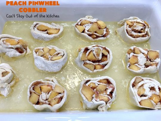 Peach Pinwheel Cobbler | Can't Stay Out of the Kitchen | this is one fantastic #PeachCobbler! #Peaches are wrapped up in dough pinwheel fashion. Syrup is poured over top before baking. The pinwheels absorb the syrup & puff up really large. This is absolutely heavenly. Wonderful #summer #dessert. #PeachDessert #cobbler #PeachPinwheelCobbler #Canbassador #WashingtonStateFruitCommission #WashingtonStoneFruitGrowers #WashingtonStateStoneFruitGrowers