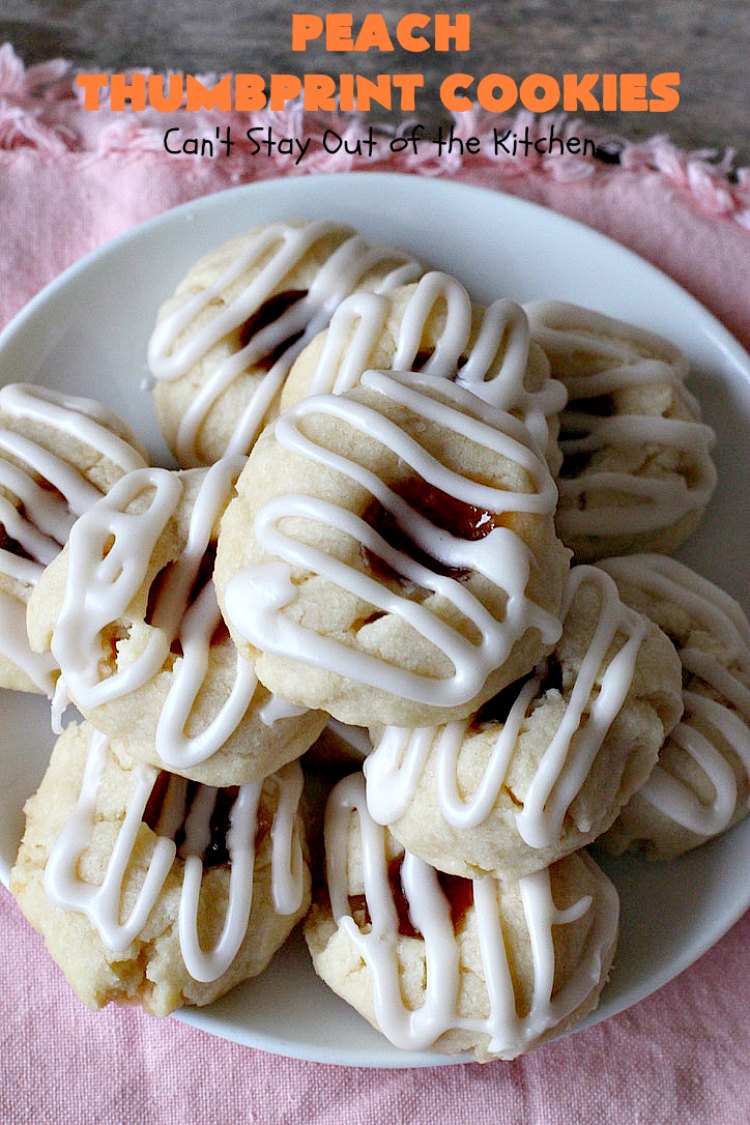 Peach Thumbprint Cookies | these fantastic little #cookies are terrific for #holiday #baking & #ChristmasCookieExchanges. They're filled with #peach jam & iced with a heavenly vanilla powdered sugar icing. #dessert #holiday #HolidayDessert ChristmasDessert #ChristmasCookie #PeachDessert #ThumbprintCookie