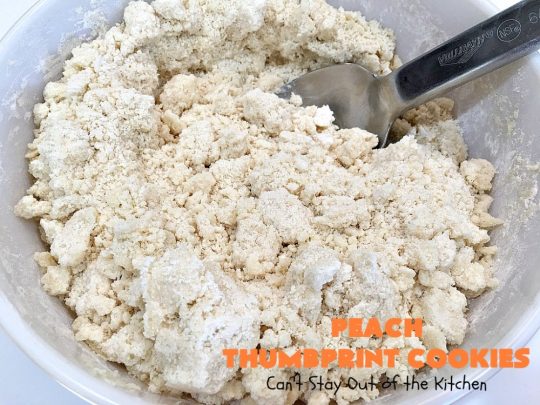 Peach Thumbprint Cookies | these fantastic little #cookies are terrific for #holiday #baking & #ChristmasCookieExchanges. They're filled with #peach jam & iced with a heavenly vanilla powdered sugar icing. #dessert #holiday #HolidayDessert ChristmasDessert #ChristmasCookie #PeachDessert #ThumbprintCookie