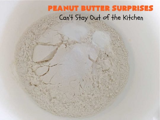 Peanut Butter Surprises | Can't Stay Out of the Kitchen | Surprise your family with these amazing #cookies. They're chocked full of #PeanutButter & #ReesesPeanutButterCups. Every bite will rock your world! Great for #tailgating or #holiday parties. #chocolate #dessert #ChocolateDessert #PeanutButterDessert #HolidayDessert #ReesesPeanutButterCupsDessert #PeanutButterSurprises